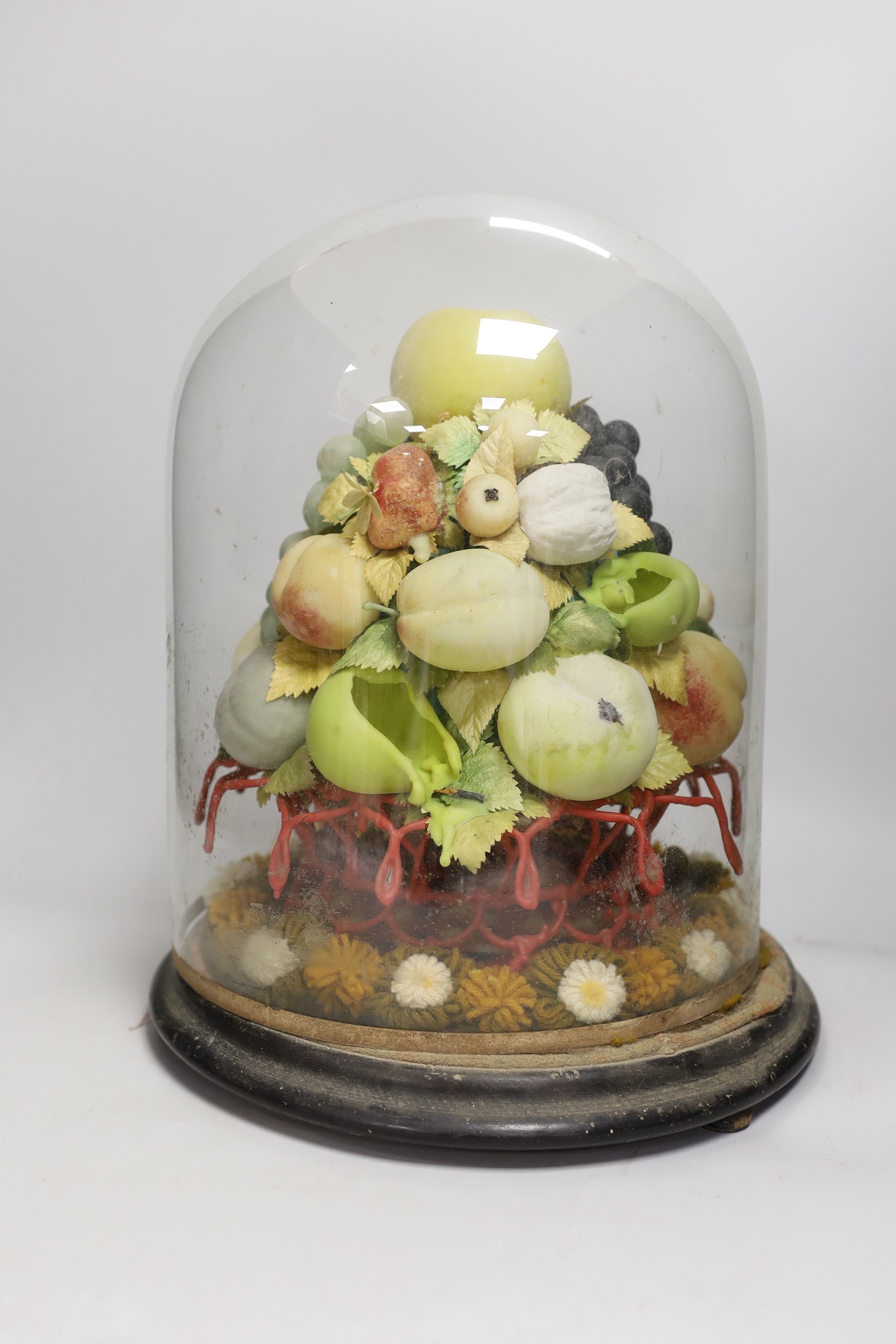 A Victorian wax fruit and woolwork arrangement under a glass dome, 36cm tall
